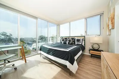 a bedroom with a bed and large windows at NEW Organic Modern Luxury 1BD/1BA- close to everything! in San Diego