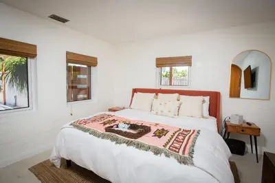 a white bedroom with a large bed with white sheets at Private Hacienda with Heated Pool and Spa with Amazing Views in Del Mar