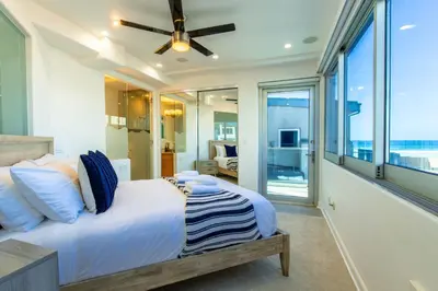 a bedroom with a bed and a large window at Ocean view, two-level condo with stunning view, decks, fast WiFi & fireplace in San Diego