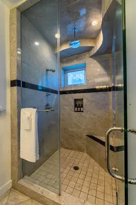 a shower with a glass door in a bathroom at Ocean view, two-level condo with stunning view, decks, fast WiFi & fireplace in San Diego