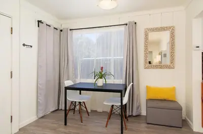a dining room with a table and chairs and a window at Mission Bay Cottage - Bay View Patio, Parking, WasherDryer in San Diego