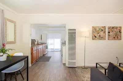a living room with a couch and a table at Mission Bay Cottage - Bay View Patio, Parking, WasherDryer in San Diego