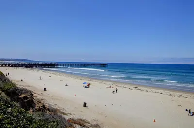 a group of people on a beach near the ocean at Mission Bay Cottage - Bay View Patio, Parking, WasherDryer in San Diego
