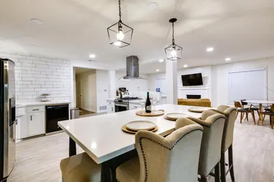 a kitchen and dining room with a white table and chairs at Spacious Home with Yard about 7 Mi to Dtwm San Diego! in San Diego