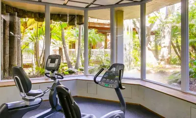 two exercise bikes in a gym with windows at Brooks Beach Vacations Villa C205 Oceanside in Oceanside