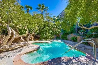 a pool in the middle of a yard with trees at Brooks Beach Vacations Cottage G5 Oceanside in Oceanside