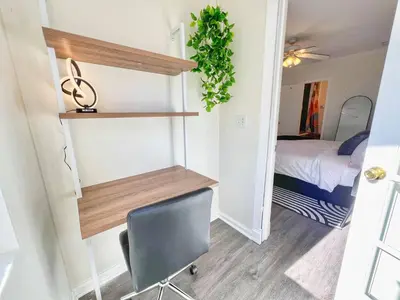 a room with a desk and a chair and a bed at Groovy Getaway Retro Vibes in North Park, SD in San Diego