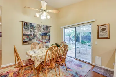 a dining room with a table and chairs and a ceiling fan at Peaceful El Cajon Vacation Rental with Patio and Yard! in El Cajon