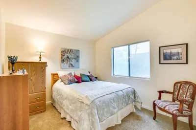 a bedroom with a bed and a window and a chair at Peaceful El Cajon Vacation Rental with Patio and Yard! in El Cajon