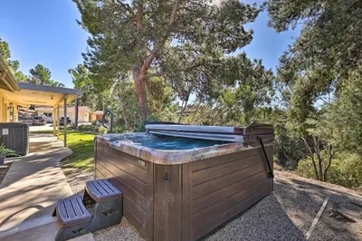 a hot tub in a yard with two chairs at Charming Temecula Home with Hot Tub, Mountain Views! in Temecula