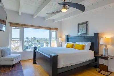 a bedroom with a large bed and a window at Spacious Ocean View Blufftop Compound in San Clemente