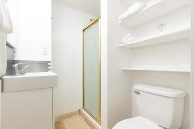 a bathroom with a toilet and a sink and a mirror at Sea View Escape Unit #2 in San Clemente