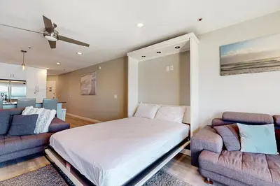 a bedroom with a bed and a couch at Blue Wave Penthouse in San Diego