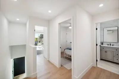 a white room with a sink and a bedroom at Coastal Living at its Finest Pacific Beach in San Diego