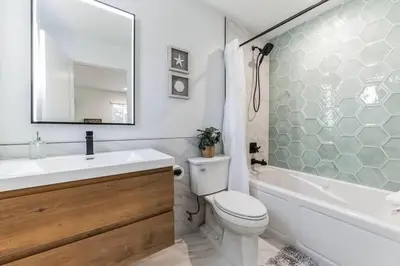 a bathroom with a sink and a toilet and a tub at Coastal Living at its Finest Pacific Beach in San Diego