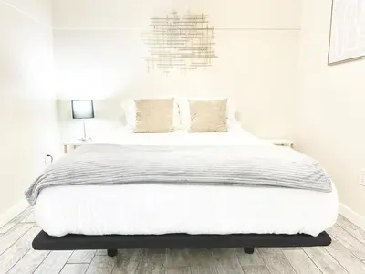 a white bedroom with a large white bed with pillows at Modern Retreat Just Outside The City in San Diego