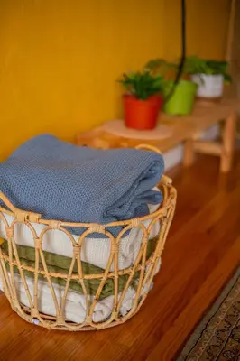 a basket filled with towels on top of a wooden floor at Cozy Home with Downtown View in San Diego