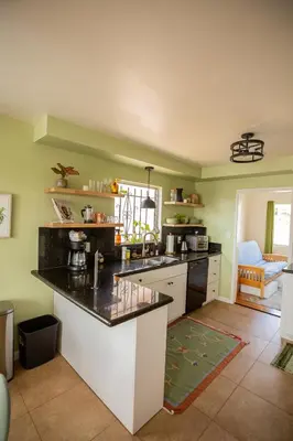 a kitchen with green walls and a counter top at Cozy Home with Downtown View in San Diego