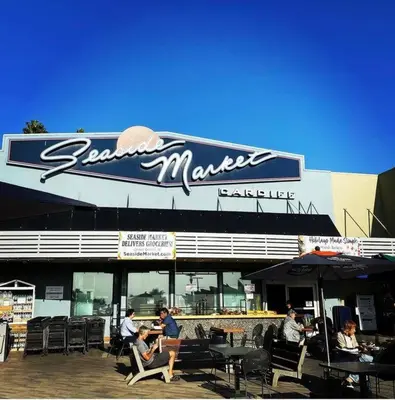 people sitting in chairs in front of a restaurant at Coastal Paradise Blocks from Beacon's Beach in Encinitas