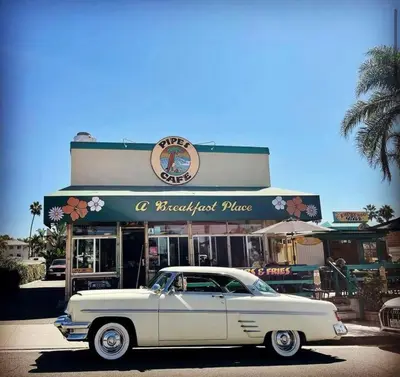 a white car parked in front of a restaurant at Coastal Paradise Blocks from Beacon's Beach in Encinitas