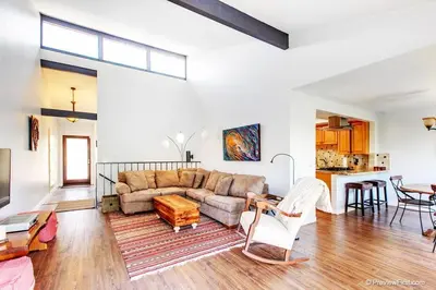 a living room with a couch and a table at Coastal Paradise Blocks from Beacon's Beach in Encinitas