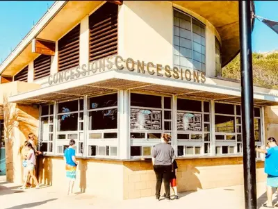 a group of people standing outside of a store at Coastal Paradise Blocks from Beacon's Beach in Encinitas