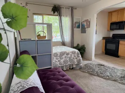 a living room with a bed and a purple couch at Min to Downtown/Beach/Parks Free Parking Sleep 3+ in San Diego