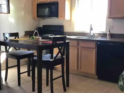 a kitchen with a table with chairs and a stove at Min to Downtown/Beach/Parks Free Parking Sleep 3+ in San Diego