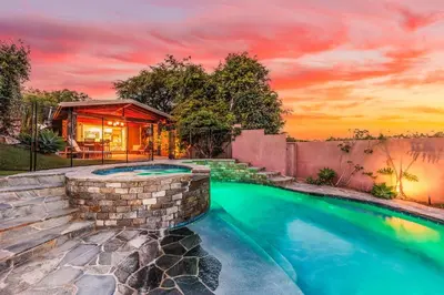 a home with a swimming pool and a house at CBS-501 - Cardiff Hillside Hideaway in Cardiff-by-the-Sea