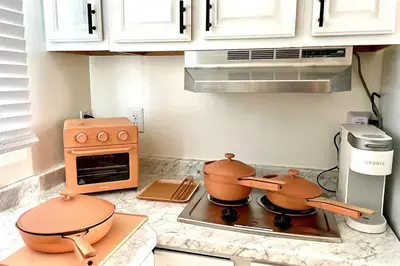 a kitchen with two pots on top of a stove at Sandcastle Cottage 22 in Oceanside
