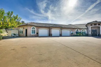 a large house with two garage doors in a driveway at Cozy Alpine Cottage Near Casinos and Trails! in Alpine