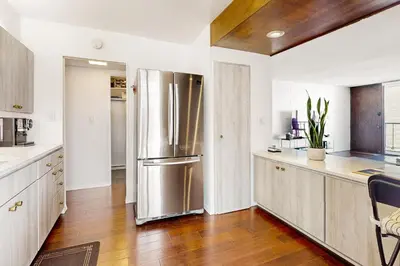 a large kitchen with a stainless steel refrigerator at Seaside Serenity Haven -30 night min in San Diego
