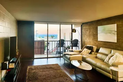 a living room with a couch and a table at Seaside Serenity Haven -30 night min in San Diego
