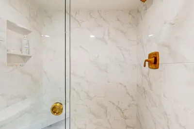 a bathroom with a shower with a glass door at Seaside Serenity Haven -30 night min in San Diego