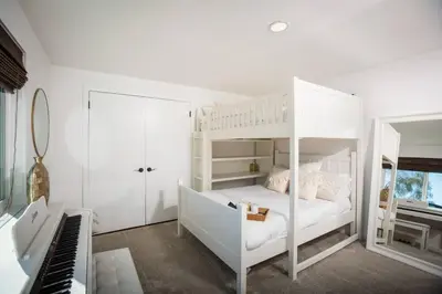 a bedroom with a white bunk bed and a piano at Amazing Views with Heated Pool and Jacuzzi Near Beach in Solana Beach