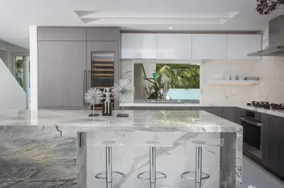 a kitchen with a marble counter and stools at Amazing Views! Walk to the Beach! Pool and Spa! in San Diego
