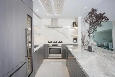 a kitchen with white marble countertops and a stove at Amazing Views! Walk to the Beach! Pool and Spa! in San Diego