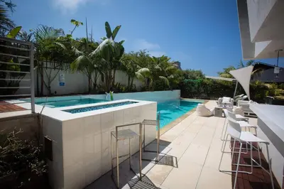 a patio with a swimming pool and some chairs at Amazing Views! Walk to the Beach! Pool and Spa! in San Diego