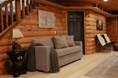 a living room with a couch in a cabin at Award-Winning A-Frame with Views and Cedar Hot Tub in Julian