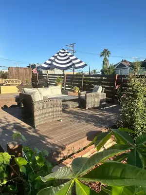 a patio with two couches and an umbrella at Guest House next to Little Italy in San Diego