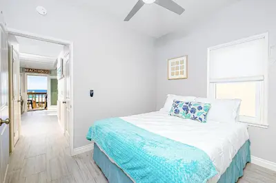 a white bedroom with a bed and a window at Stunning Ocean Views - Recently Renovated Home & Warm Sunsets in San Diego