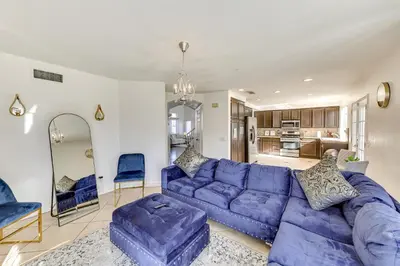 a living room with a purple couch and a kitchen at Lake Elsinore Home with Pool - 44 Mi to Disneyland! in Lake Elsinore