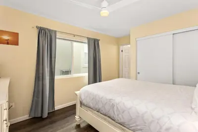 a bedroom with a bed and a window at Oceanfront 3-unit complex - Private Deck - BBQ in Oceanside