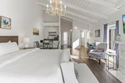 a bedroom with a large bed and a living room at Oceanfront 3-unit complex - Private Deck - BBQ in Oceanside