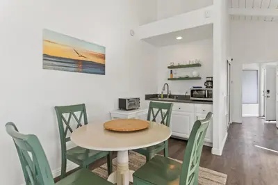 a kitchen and dining room with a table and chairs at Romantic Getaway - Luxury Oceanfront Studio - Private Balcony - Fireplace in Oceanside