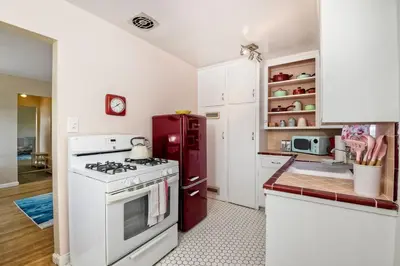 a kitchen with a white stove and a red refrigerator at Walk 2 Beach, EV Charger, Outdoor Dining, 2 Units in Carlsbad