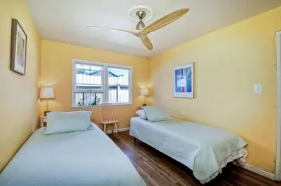 two beds in a room with two windows at Walk 2 Beach, EV Charger, Outdoor Dining, 2 Units in Carlsbad