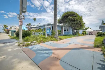 a street sign on a sidewalk in front of a house at Walk 2 Beach, EV Charger, Outdoor Dining, 2 Units in Carlsbad