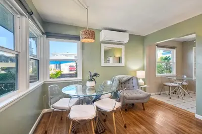 a dining room with a glass table and chairs at Walk To Beach - EV Charger - Outdoor Dining - 2BR in Carlsbad