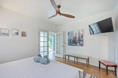 a bedroom with a bed and a ceiling fan at La Costa Escape - Pool, BBQ, Gated Parking in Encinitas
